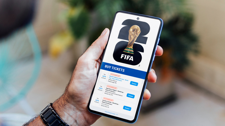 A person buying FIFA World Cup tickets on a mobile phone