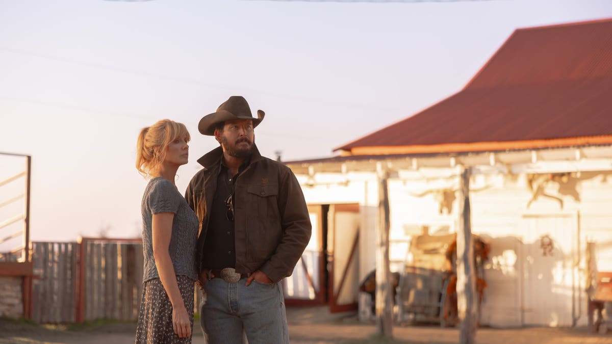 Kelly Reilly as Beth Dutton and Cole Hauser as Rip Wheeler standing in Dutton Ranch