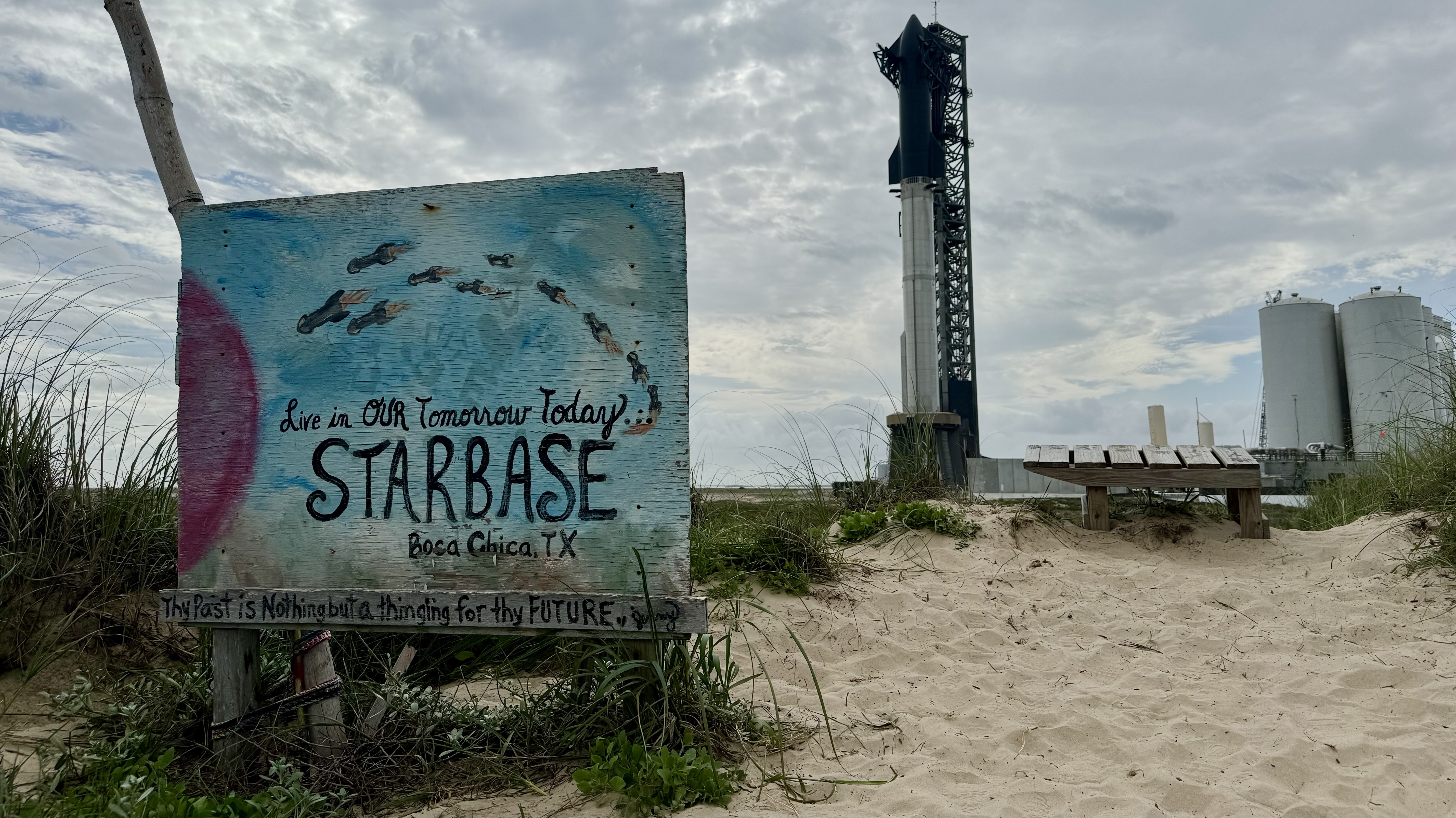 A painted wooden sign reads 'STARBASE', and a giant rocket stands in the background.
