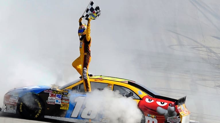 Kyle Busch celebrates his win in the NASCAR Sprint Cup Series' Autism Speaks 400 auto race, Sunday, May 16, 2010, in Dover, Del.