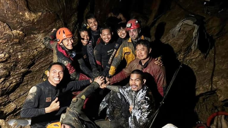 Rescue workers gathered in a flooded Laos cave to evacuate trapped locals.