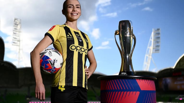Mackenzie Barry of Wellington Phoenix poses with the A-League women trophy at Melbourne's AAMI Park. 