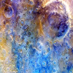 Captured by Psyche’s multispectral imager instrument, this is an enhanced-color view of the large double-ring crater Huygens (upper right; about 290 miles, or 470 kilometers, in diameter) and the surrounding heavily cratered southern highlands. Credit: NASA/JPL-Caltech/ASU
