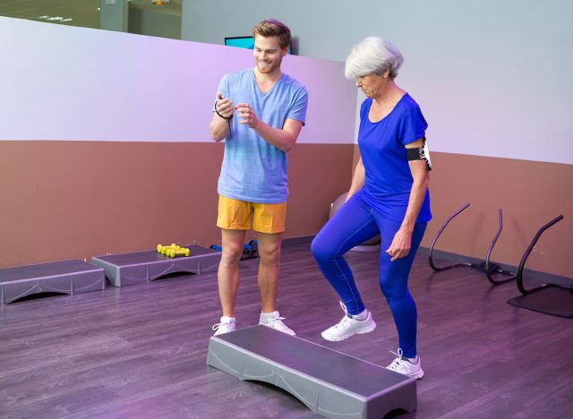 athletic woman senior doing aerobic class