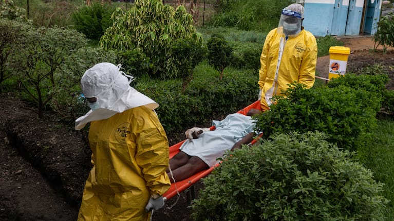 Medical staff carry an Ebola patient to a treatment centre.