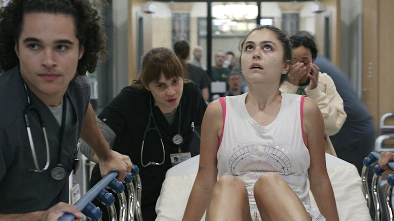 Jenna Burke (Mika Abdalla) being wheeled through the hospital in 