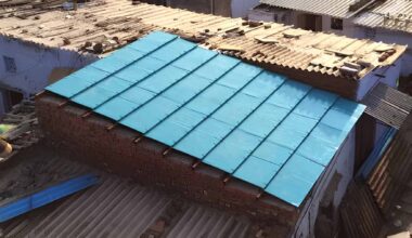 ModRoof modular panels made from recycled cardboard and coconut husk fiber being installed on a low-income home.