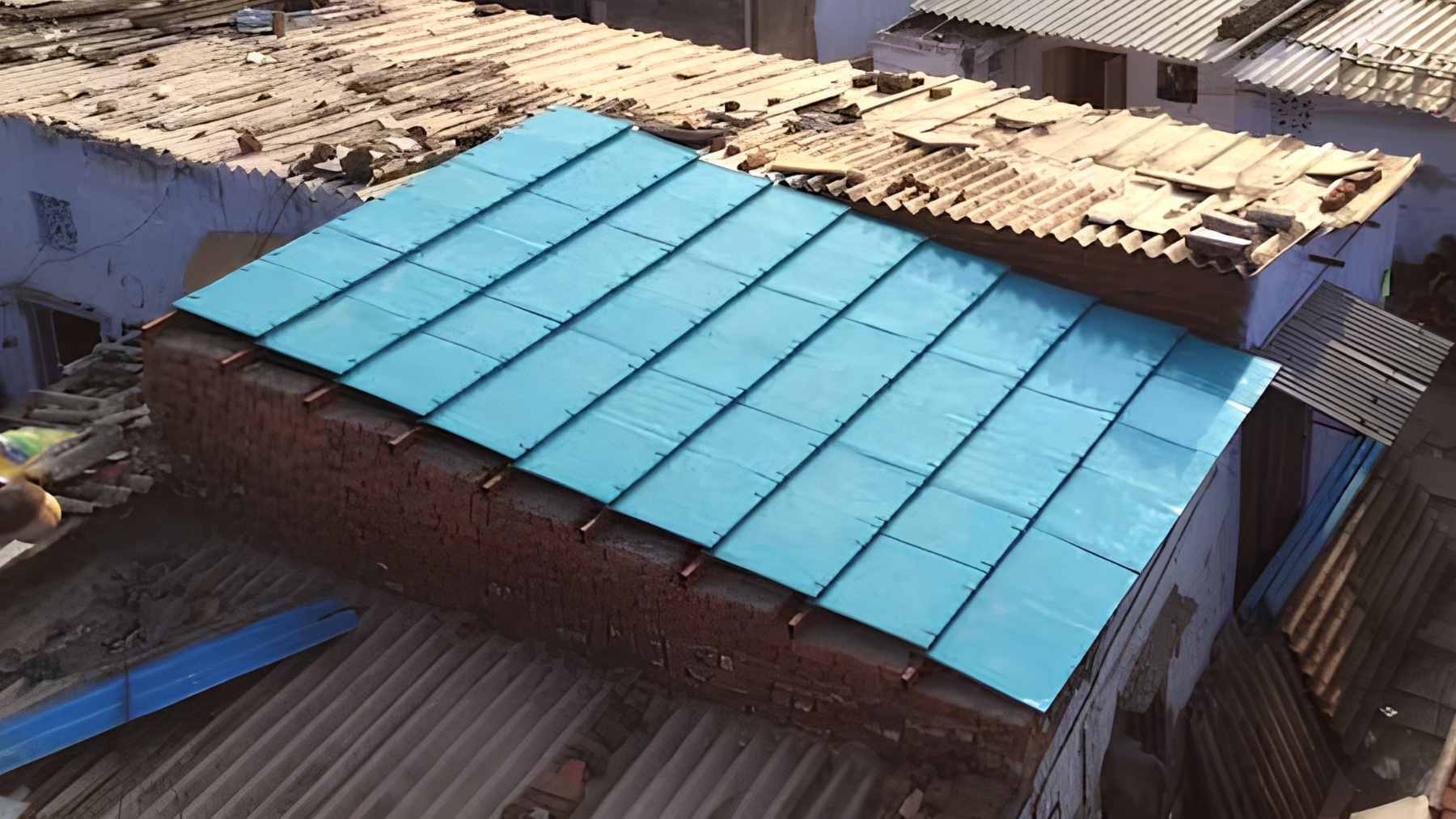ModRoof modular panels made from recycled cardboard and coconut husk fiber being installed on a low-income home.