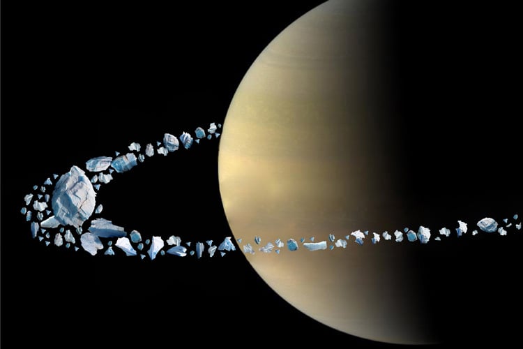 Artist's illustration of how Saturn's rings might have formed from an ancient moon being ripped apart when it orbited too close. (Credit: B. Militzer and NASA)