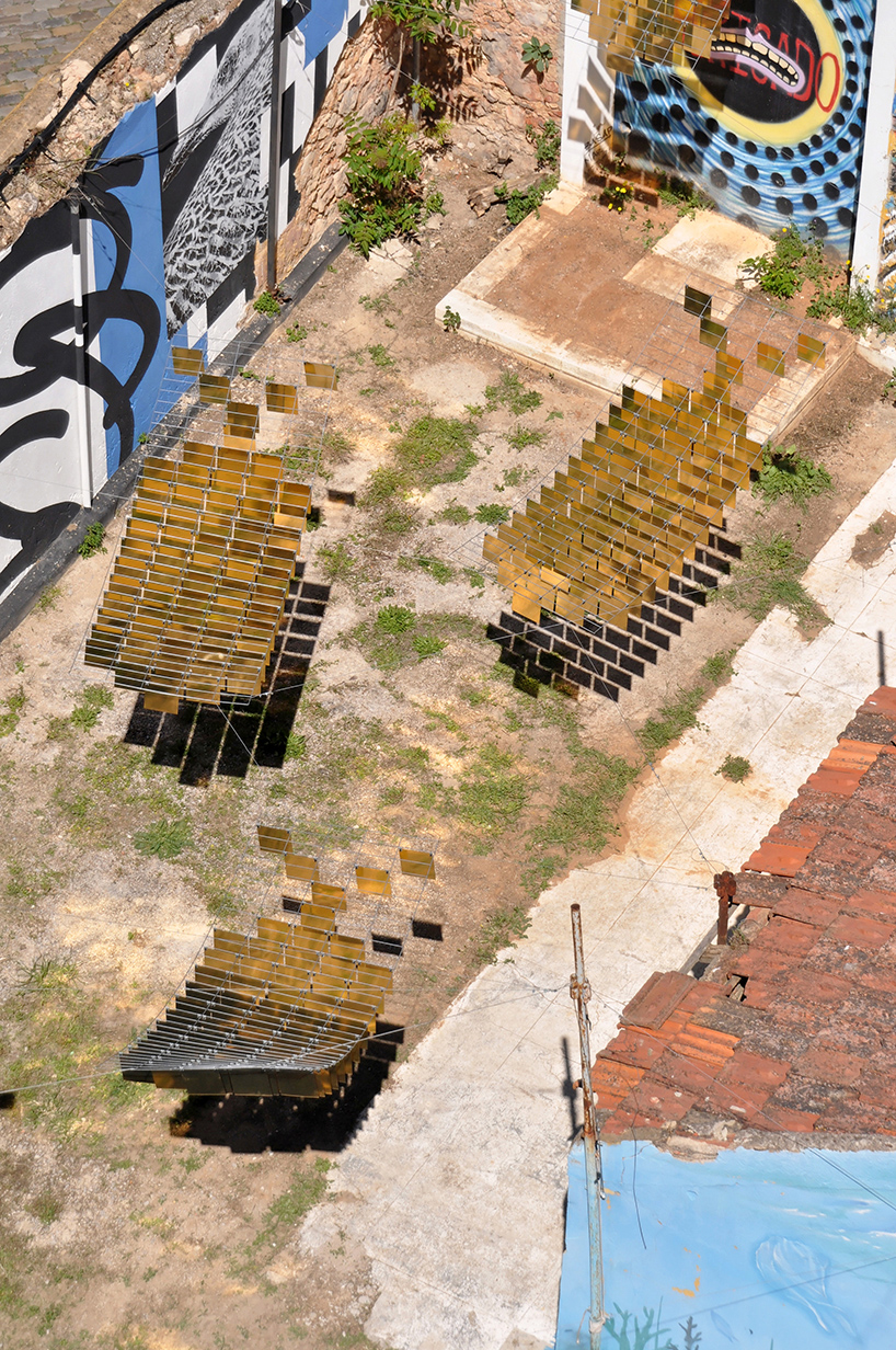 kinetic mirrored installation in portugal by moradavaga evokes a shoal of golden fish - 3