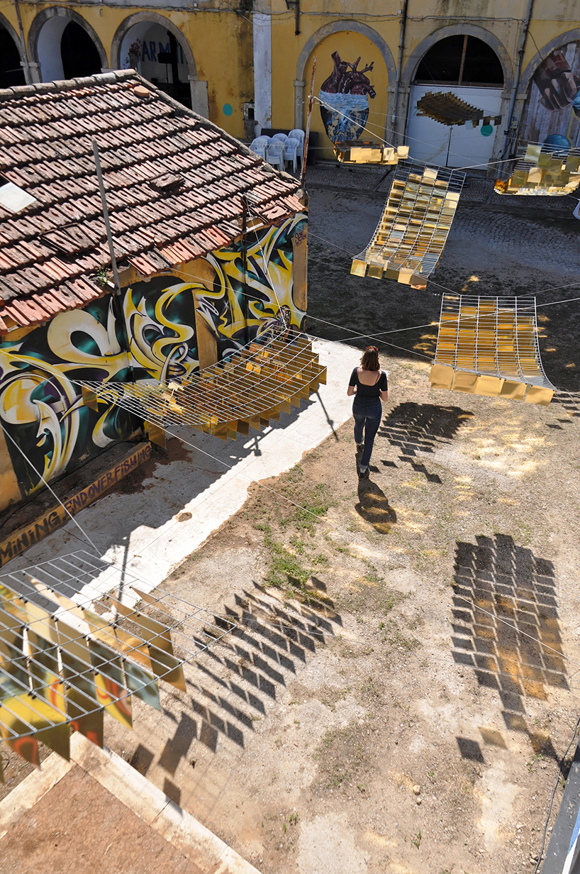 kinetic mirrored installation in portugal by moradavaga evokes a shoal of golden fish - 2