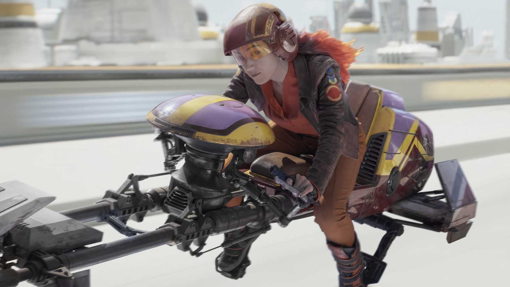 Natasha Liu Bordizzo as Sabine Wren riding a speeder bike in Ahsoka