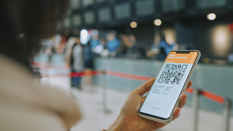 A person using a mobile app to make a movie e-ticket reservation