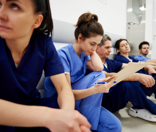 A group of nurses sitting in a hospital hallway