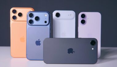 Five iPhone models standing on a white table