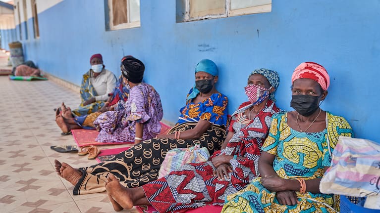 People in protective masks wait in the corridor of a hospital in Bunia, Congo.