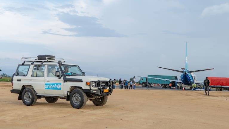 People wait in a UNICEF vehicle at Bunia National Airport.