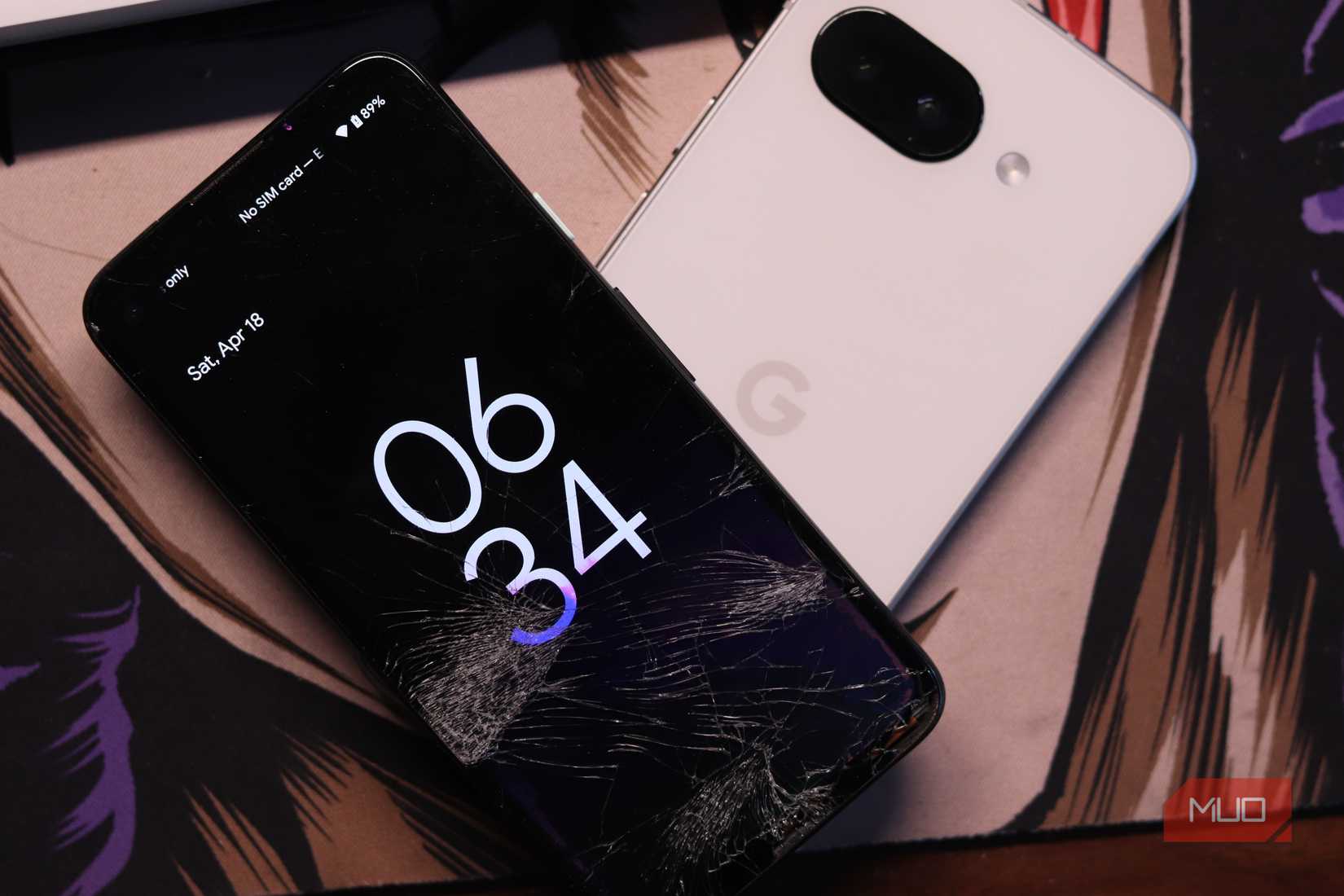 Pixel 4a kept on top of a Pixel 9a.
