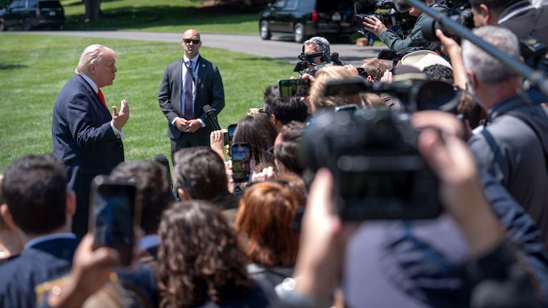 President Donald Trump speaks with reporters as he prepares to board Marine One on the South Lawn of the White House
