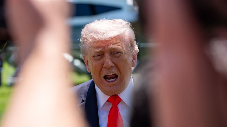President Donald Trump speaks with reporters before departing on Marine One from the South Lawn of the White House