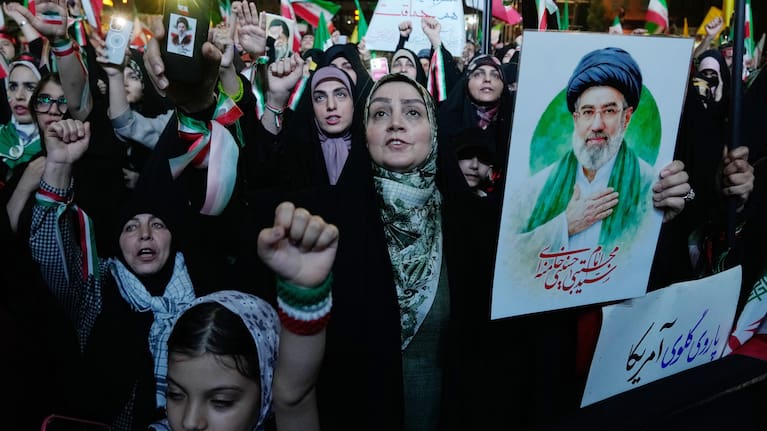Pro-government demonstrators chant slogans as one of them holds a poster of the Iranian Supreme Leader Ayatollah Mojtaba Khamenei during their gathering at Enqelab-e-Eslami, or Islamic Revolution, square in Tehran, Iran, Monday, May 4, 2026.