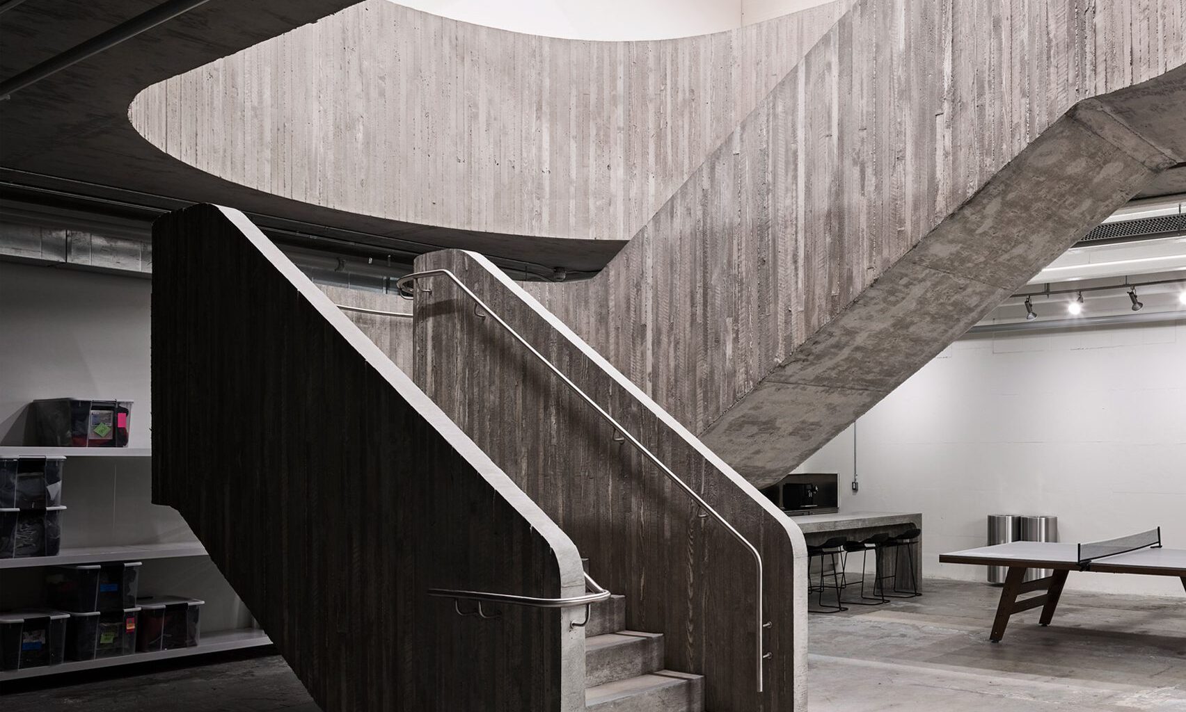 Concrete staircase anchors Purple Brand studios by Scott & Scott Architects