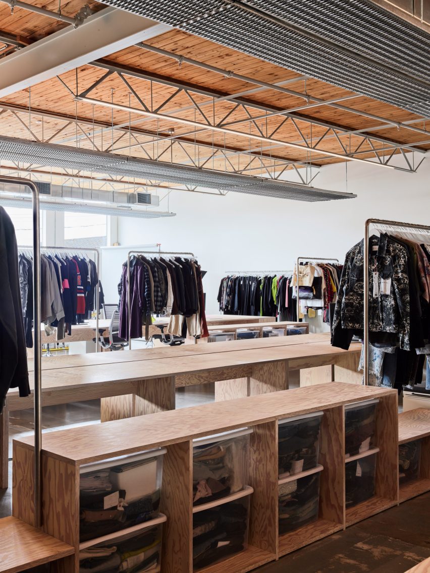 Between pigmented plywood workstations are matching storage units for samples and garments