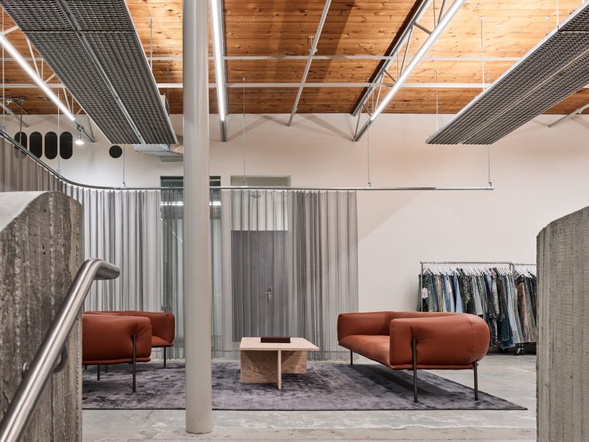 Seating area within a former industrial warehouse with a timber-plank ceiling