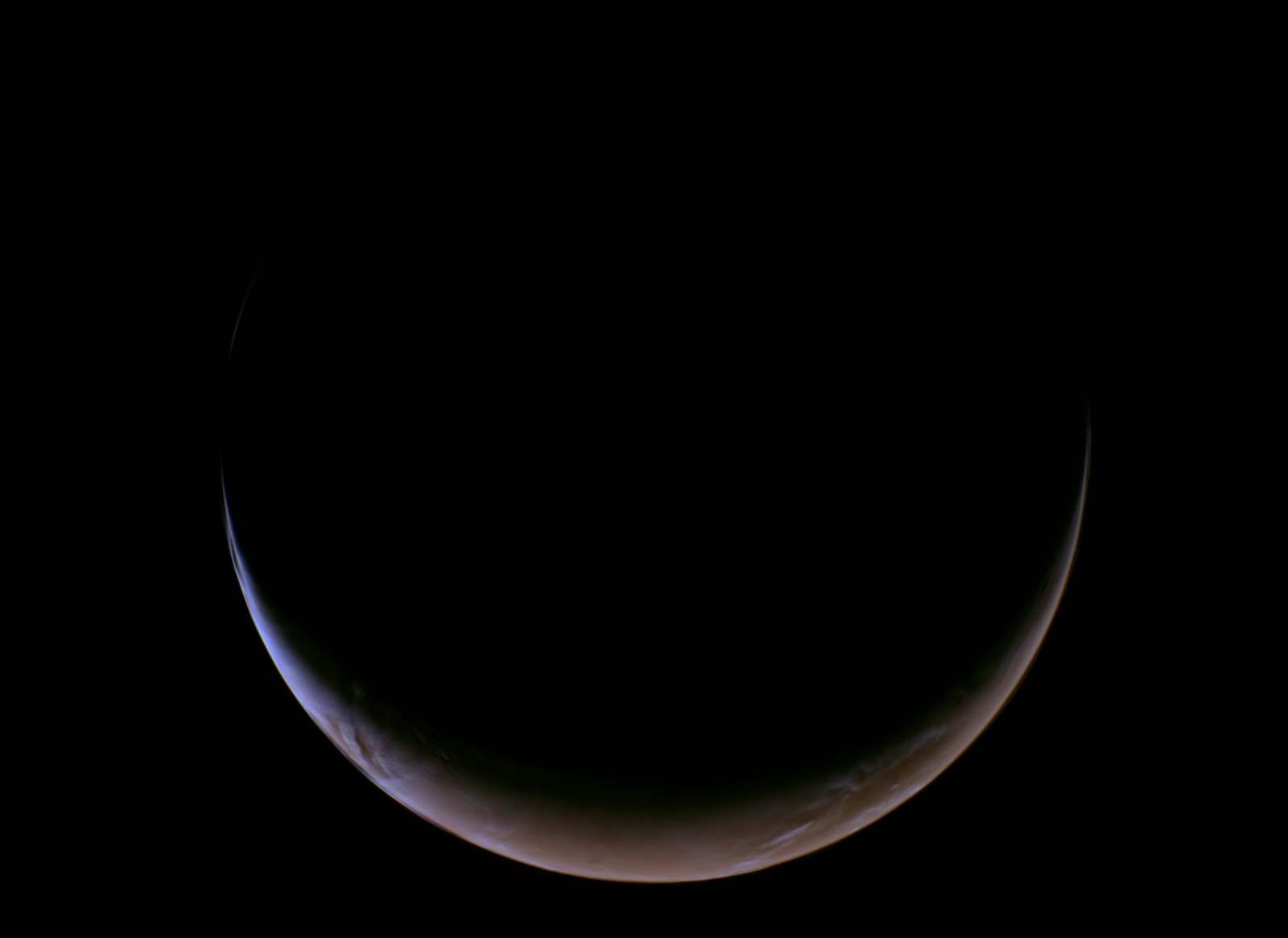 A crescent shaped sphere shows the planet Mars backlit in the darkness of space.