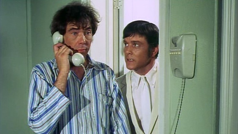 Mike Pratt as Randall on the phone next to Kenneth Cope as Hopkirk in Randall and Hopkirk (Deceased)