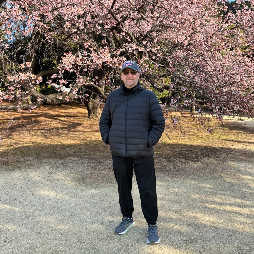 Ray Caesar enjoys plum blossom trees in Shinjuku Park on a February 2026 trip to Tokyo. A Toronto resident, Caesar finds the threats toward Canada