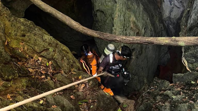 Rescuers try to reach people who have been trapped in a cave in Xaisomboun province, Laos.