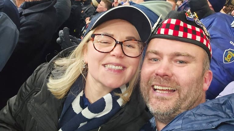 Rory Phillips-Hunter and his fiancee, Victoria Ofsarnie, pose for a selfie while attending the 2026 World Cup qualifying soccer match between Scotland and Denmark at Hampden Park in Glasgow, Scotland, Tuesday, Nov. 18, 2025. (Source: Rory Phillips-Hunter via AP)