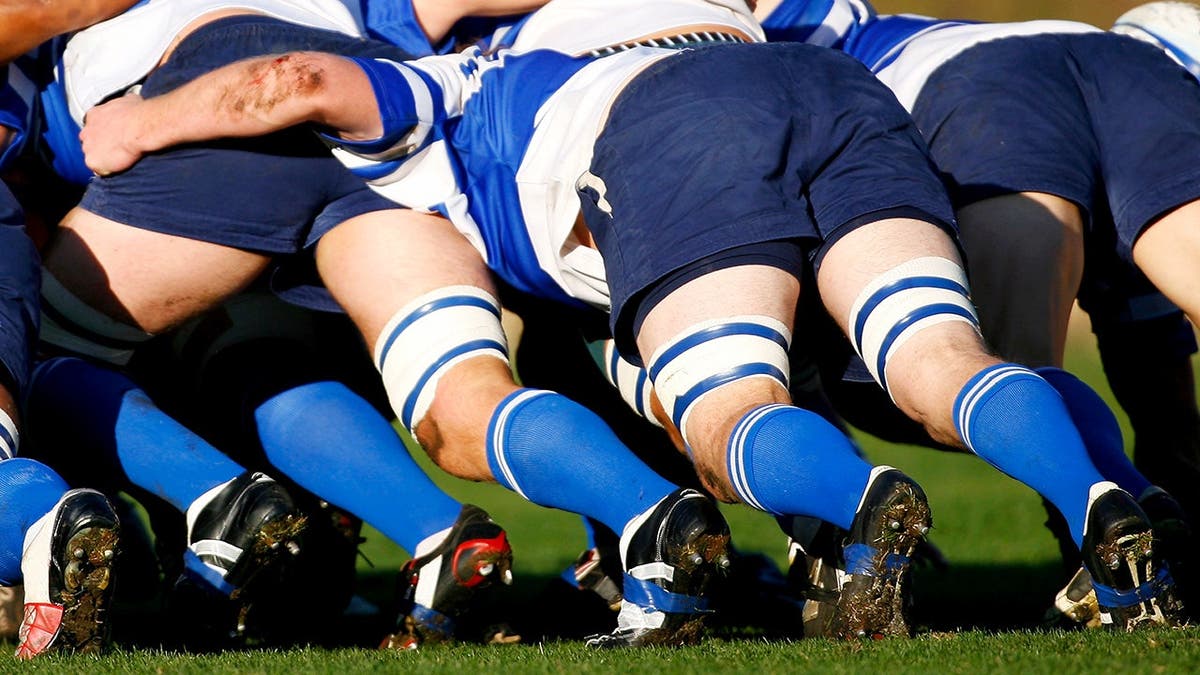 Rugby players pushing in a scrum during a match