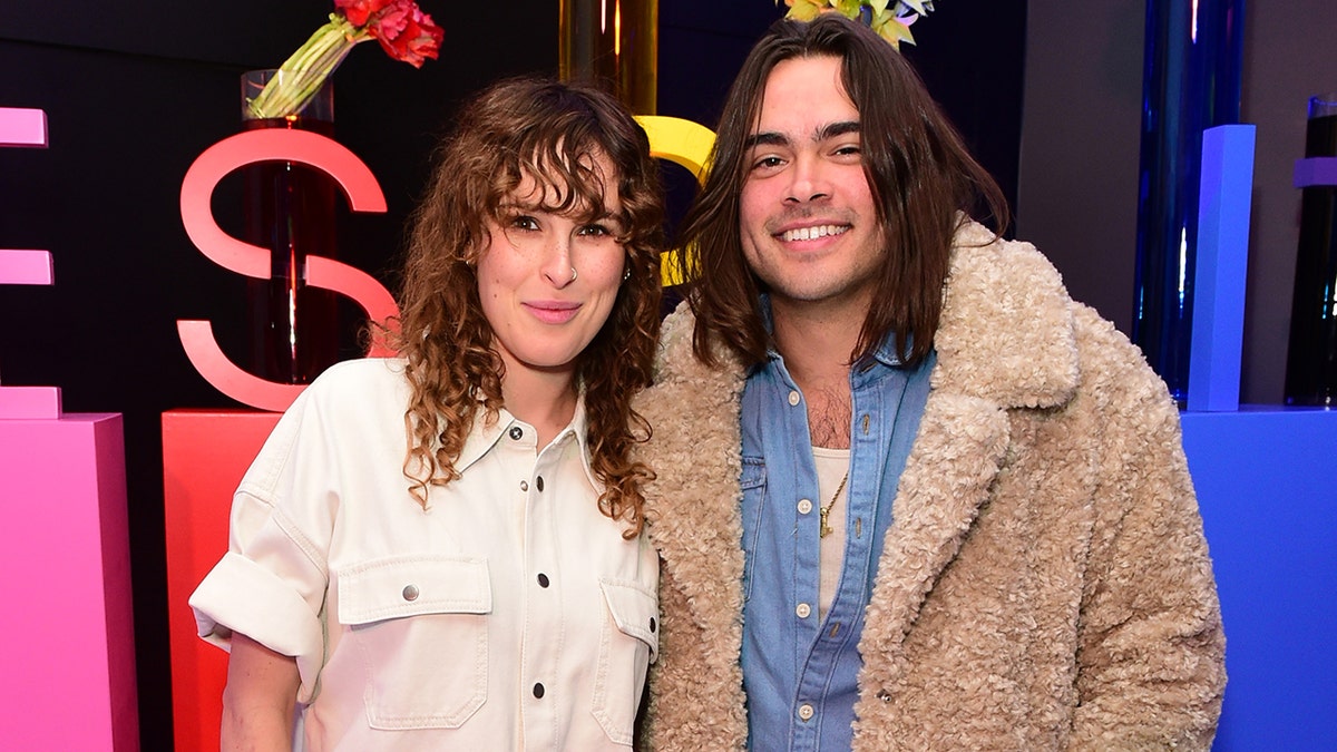 Rumer Willis and Derek Richard Thomas posing together at an event