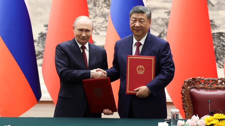 Russian President Vladimir Putin, left, and Chinese President Xi Jinping shake hands during a signing ceremony at the Great Hall of the People in Beijing, May 20, 2026.