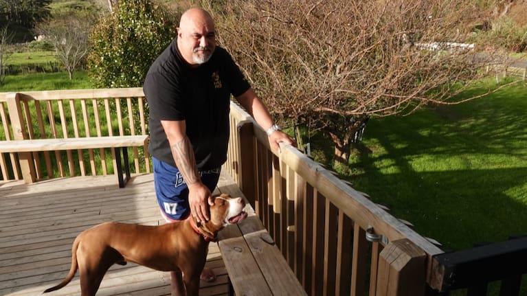 Shane Wikaira, with Kara the dog, raised his home by two metres after the 1999 flood.
