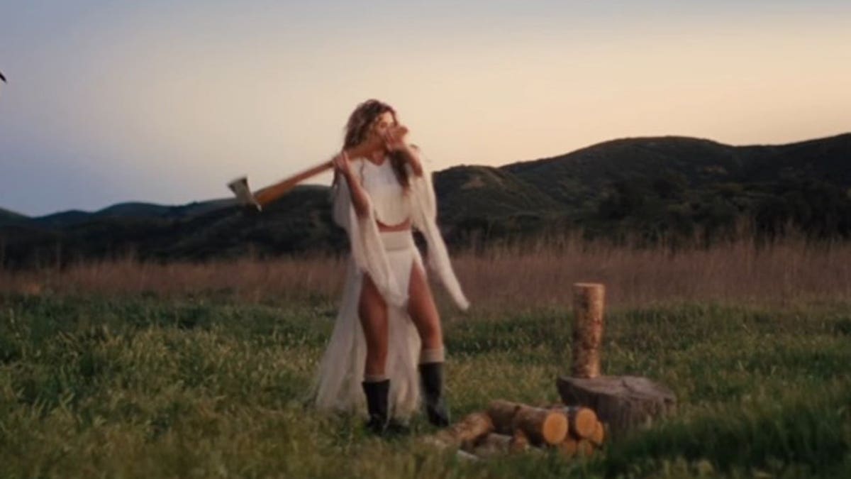Shania Twain chopping wood in an Instagram post teasing new music.