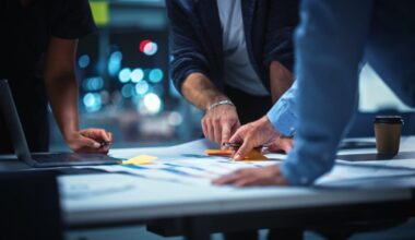 People in an office working on something at a desk