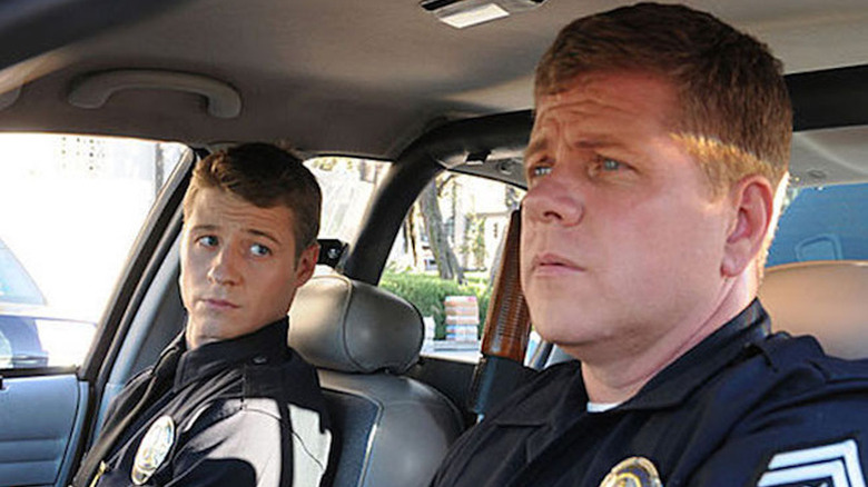 Ben McKenzie as Ben Sherman in cop car next to Michael Cudlitz as John Cooper in Southland
