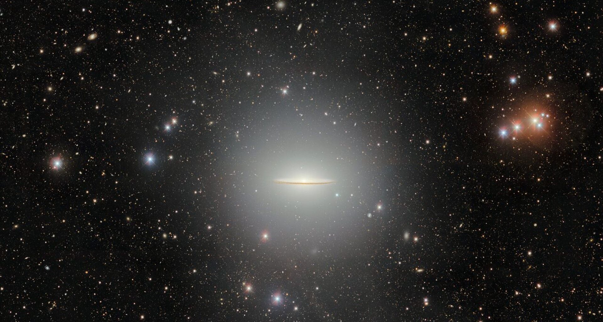 A flat disk of glowing light is seen against a starry background in space.