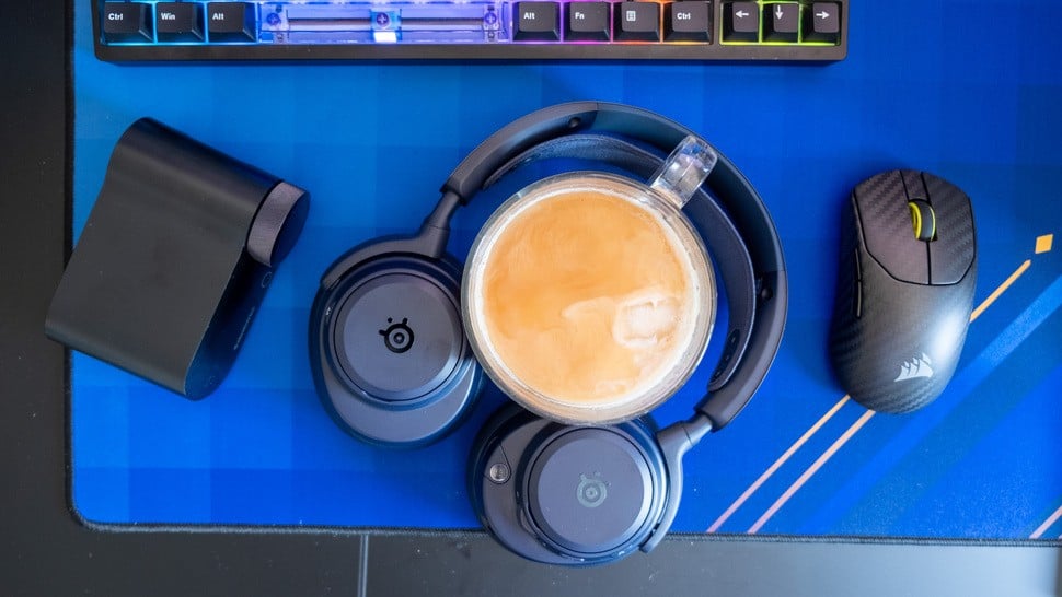 SteelSeries Arctis Nova Omni sitting on a desk with coffee