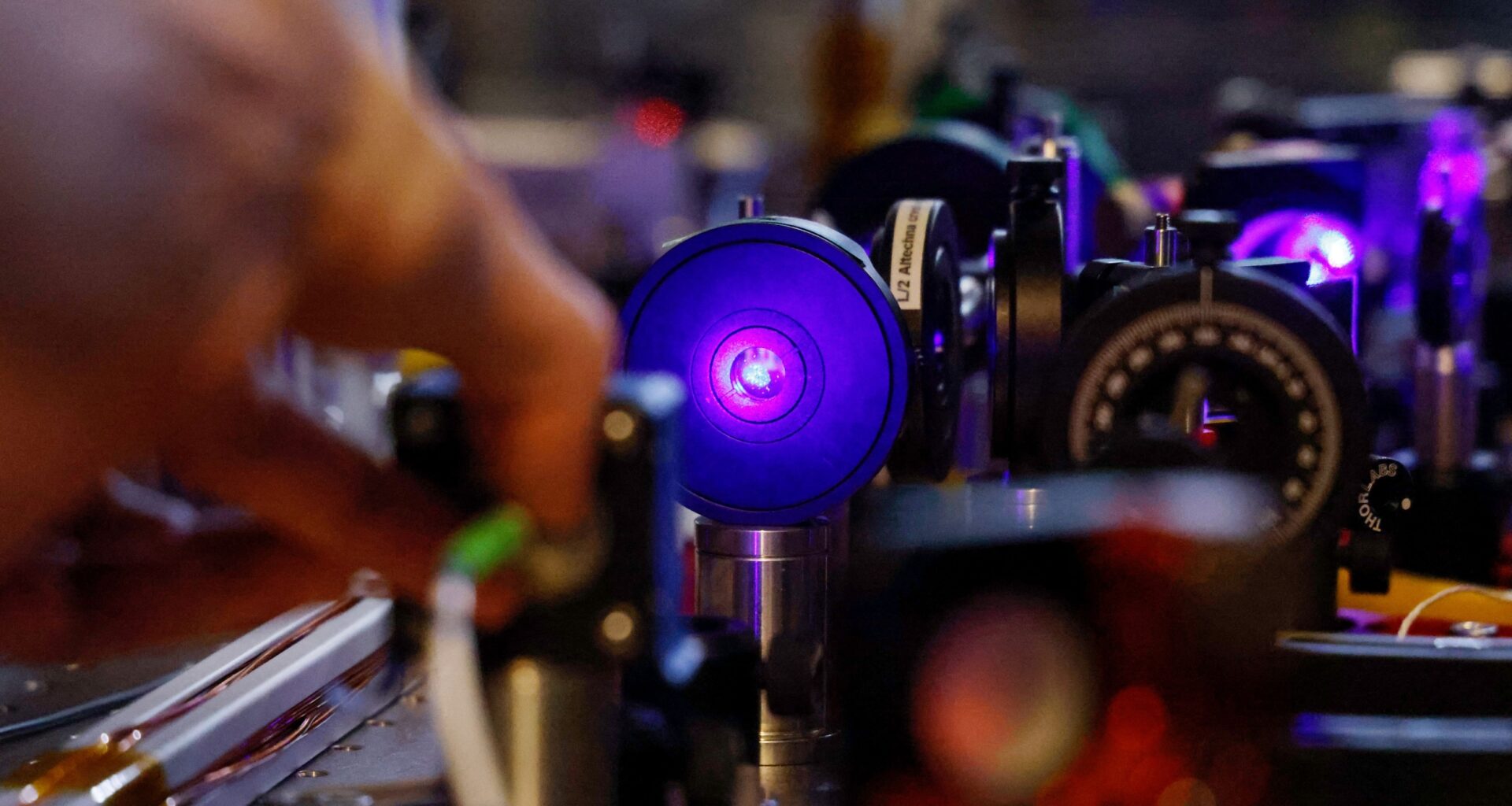 A student checks lasers for an experimentation during a visit