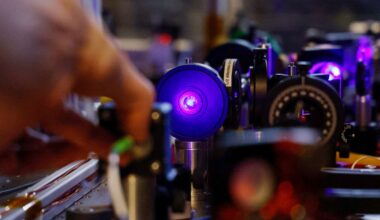 A student checks lasers for an experimentation during a visit