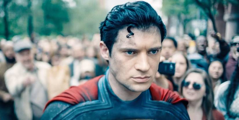 Superman after a battle, defeated, walks through a yelling crowd - David Corenswet