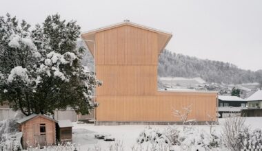 timber tower house rises from a triangular site in switzerland