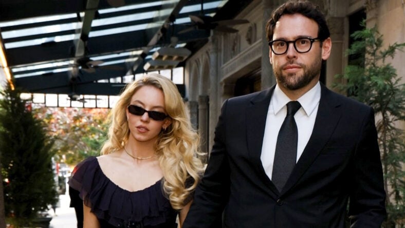 Sydney Sweeney and Scooter Braun holding hands while dressed formally