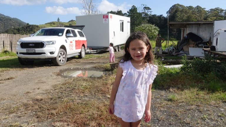 Te Aomarama, 5, waits while the family cabin is moved to higher ground.
