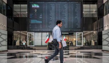 A man walks past an electronic trading board inside the Tehran Stock Exchange in Tehran, Iran. (Photo via donya-e-eqtesad.com)
