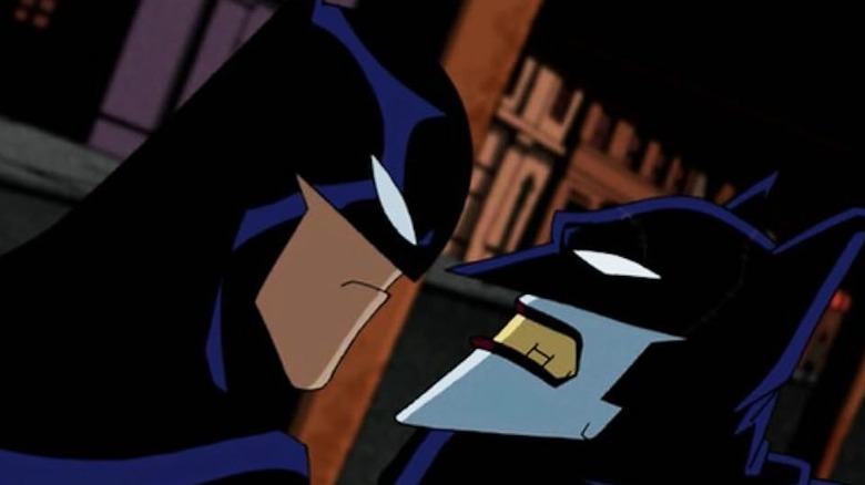 Batman grabs hold of the Joker, who is dressed in a Batman costume, on the animated series The Batman.